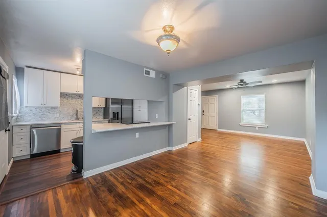 a kitchen with granite countertop a stove a sink and a refrigerator