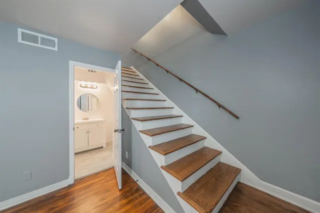 a view of entryway and hall with wooden floor
