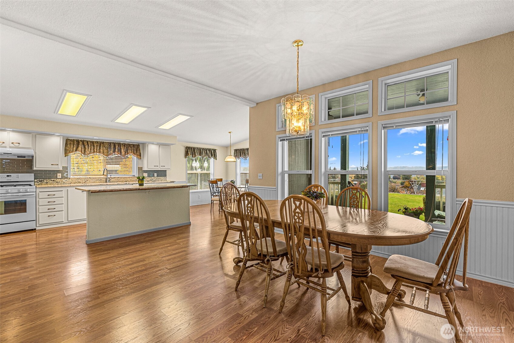 420 Sunnyslope Heights Road Wenatchee, WA 98801 - Photo 13 of 40 a view of a dining room and livingroom with furniture wooden floor a chandelier