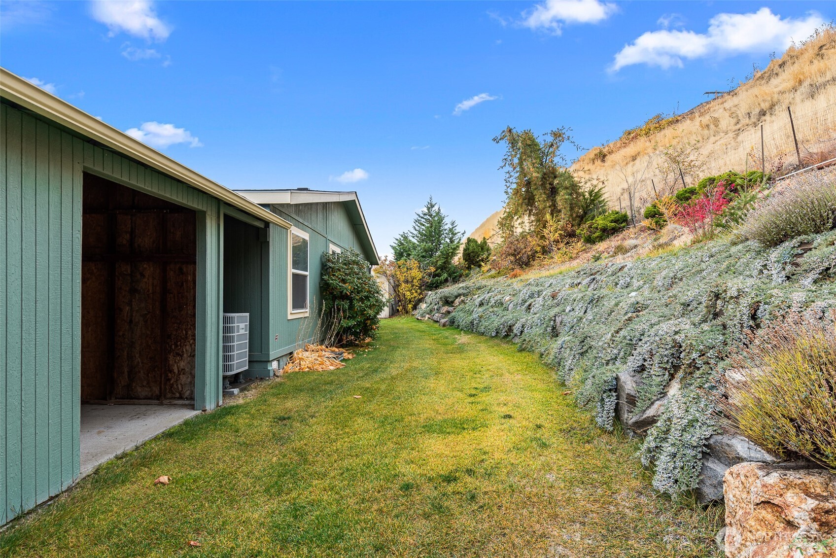 420 Sunnyslope Heights Road Wenatchee, WA 98801 - Photo 39 of 40 a view of yellow house with a yard