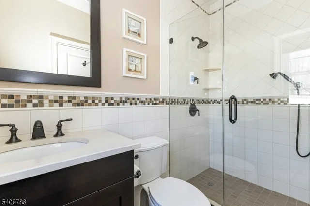 a spacious bathroom with a shower sink mirror and