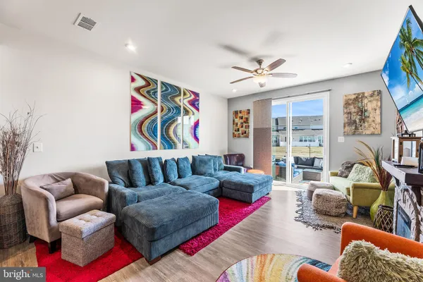 a living room with furniture ceiling fan and a rug