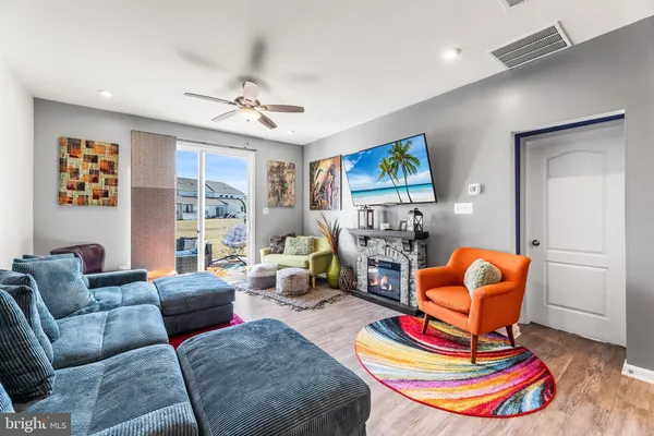 a living room with furniture fireplace and window