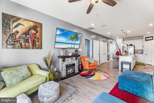 a living room with furniture and kitchen view