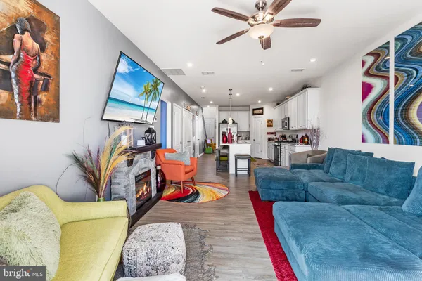 a living room with furniture and kitchen view