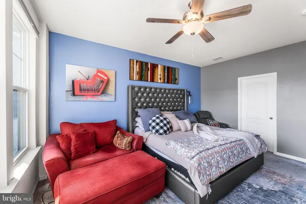 a bedroom with a bed and a couch