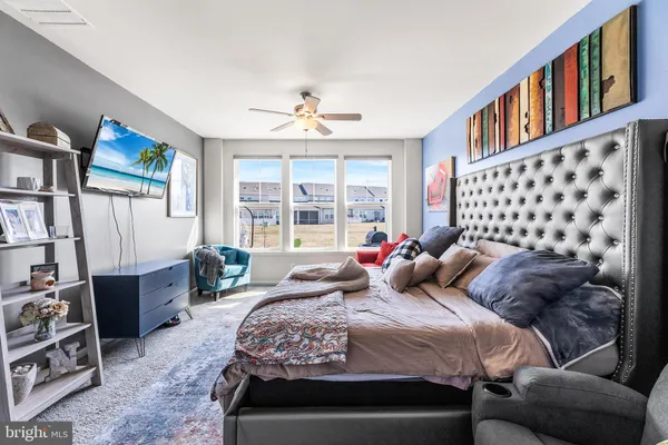 a bedroom with a bed couch and a window