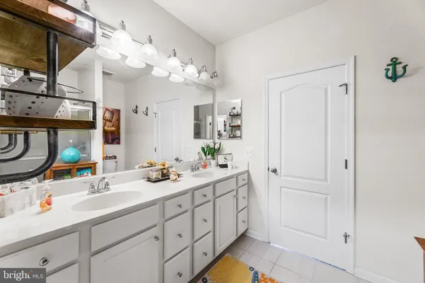 a bathroom with a sink vanity and mirror