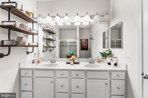 a bathroom with a sink double vanity and a mirror