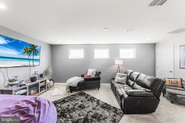 a bedroom with furniture and a rug