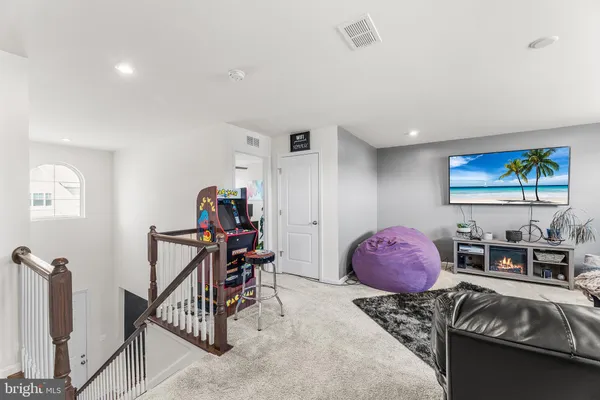 a bedroom with furniture and workout equipment