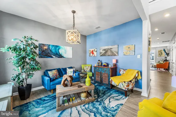 a living room with furniture and a chandelier