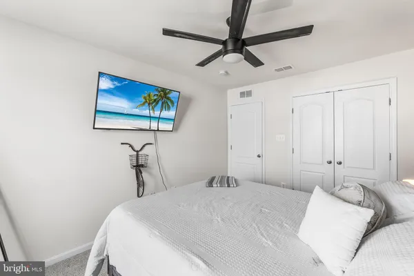 a bedroom with a bed and a painting on the wall
