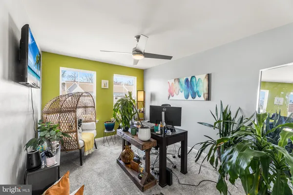a living room with furniture and a potted plant