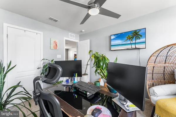 a view of a workspace with furniture and a potted plant