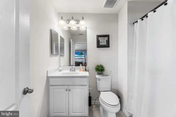 a bathroom with a toilet a sink and a mirror