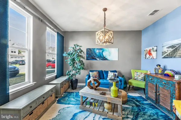a living room filled with furniture and a chandelier