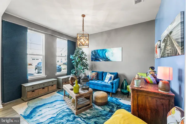 a living room with furniture and a chandelier