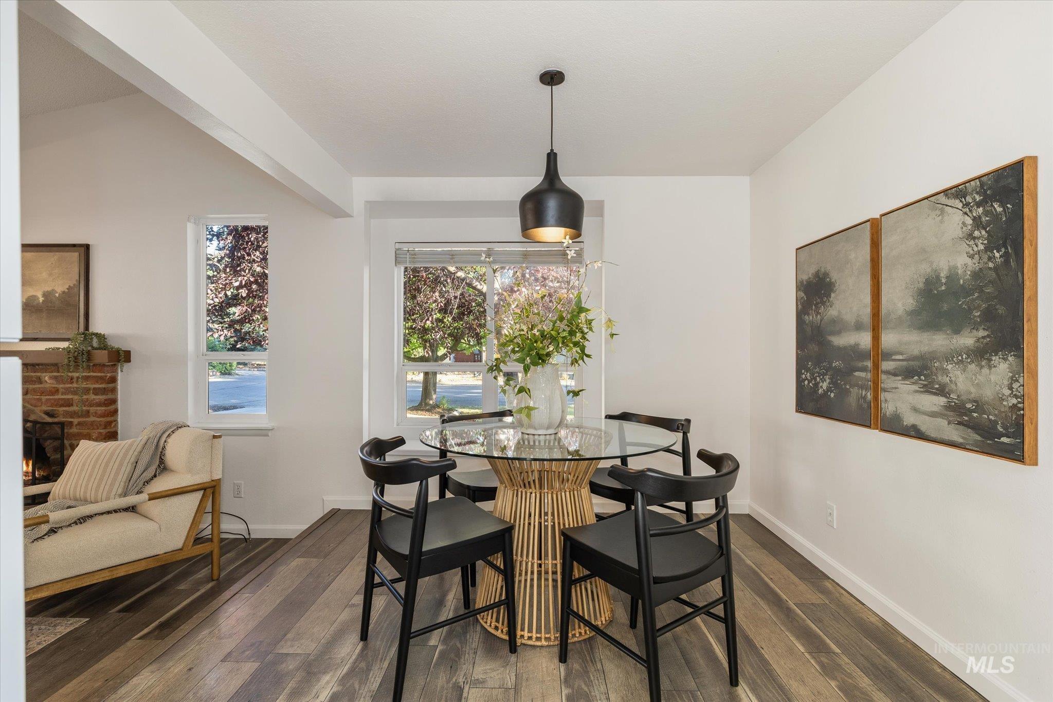 2302 Pendleton Street Boise, ID 83705 - Photo 10 of 35 Dining space featuring wood-finish flooring, a contemporary pendant light fixture, and abundant natural light from multiple windows