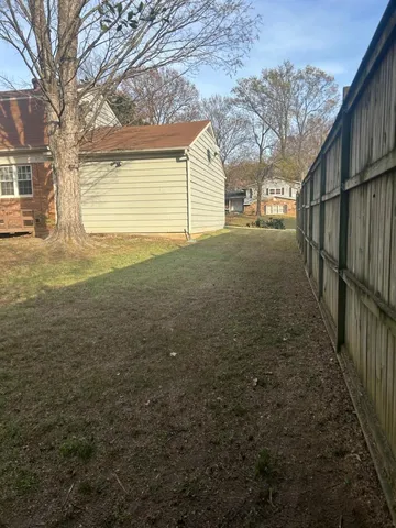 a view of a house with a backyard