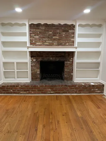 a view of fireplace and wooden floor
