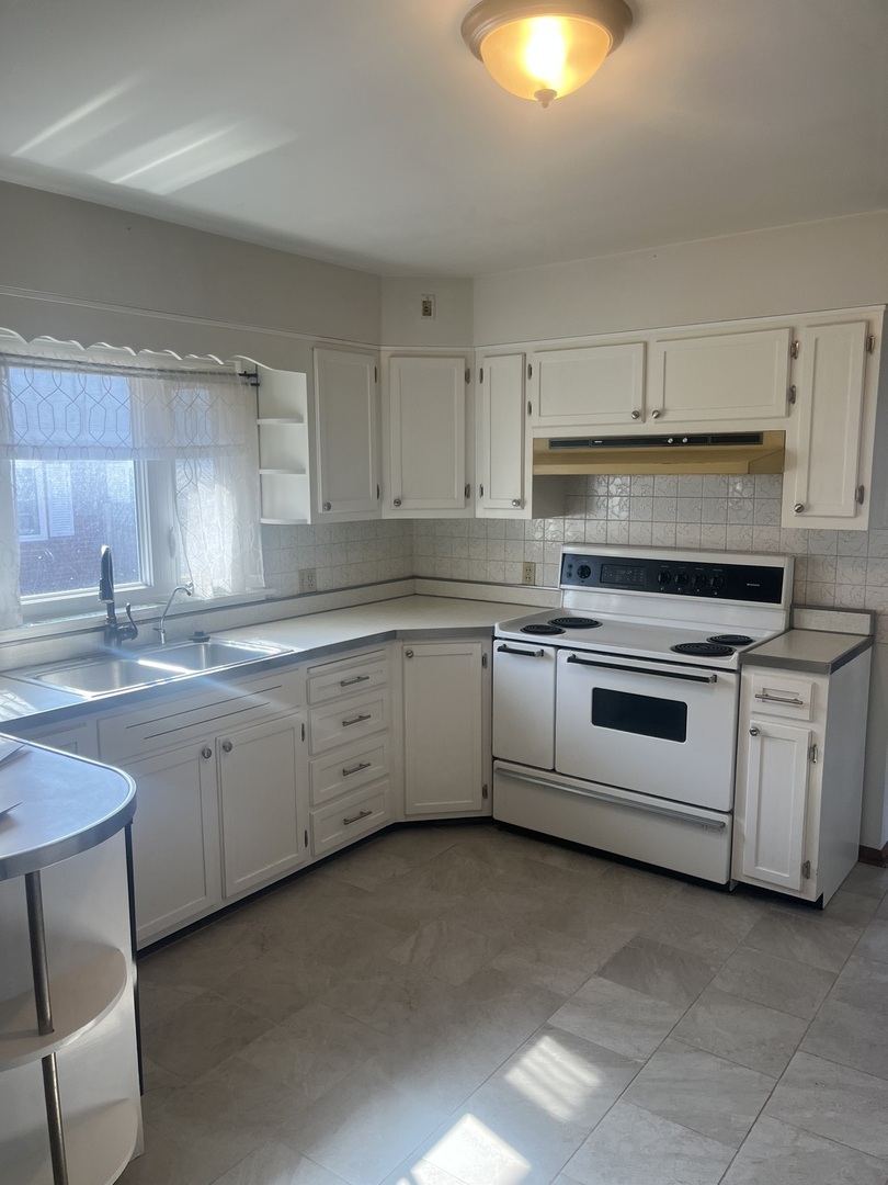 125 West Exchange Street Danvers, IL 61732 - Photo 16 of 66 a kitchen with white cabinets appliances and a sink