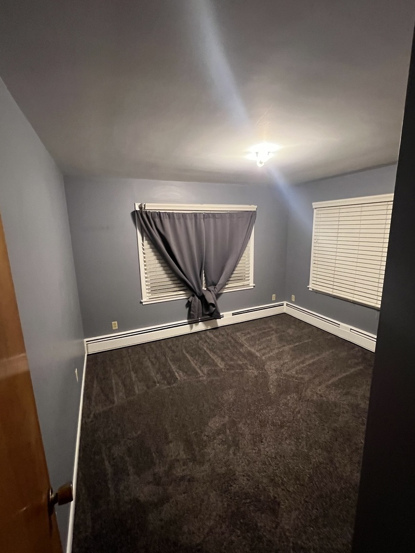 125 West Exchange Street Danvers, IL 61732 - Photo 21 of 66 wooden floor in an empty room with a window
