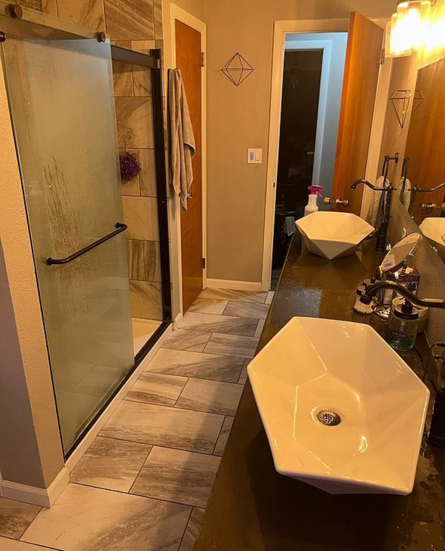 125 West Exchange Street Danvers, IL 61732 - Photo 23 of 66 a bathroom with a tub sink and a mirror