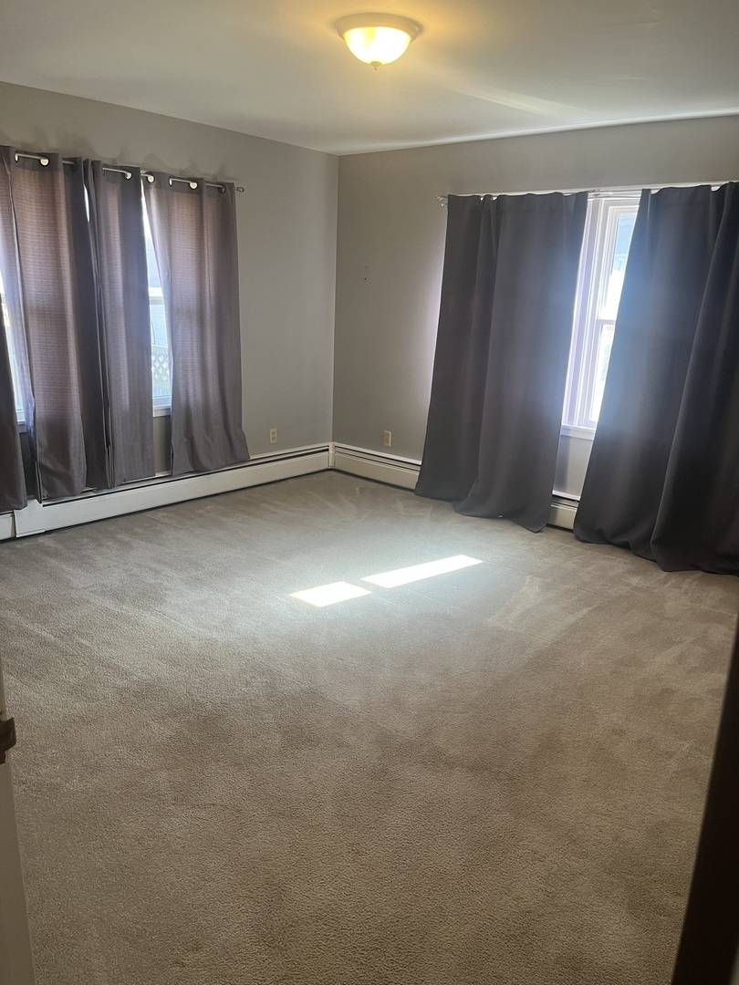 125 West Exchange Street Danvers, IL 61732 - Photo 29 of 66 an empty room with stairs and wooden floor