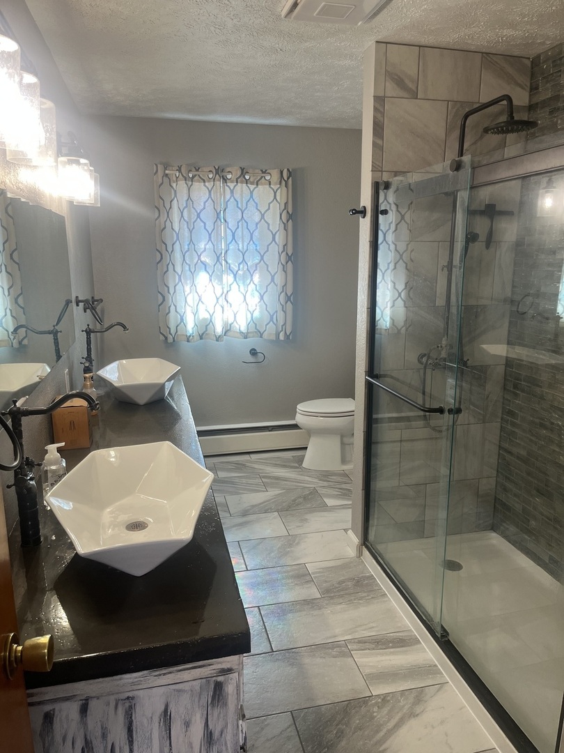 125 West Exchange Street Danvers, IL 61732 - Photo 58 of 66 a bathroom with a sink toilet and shower