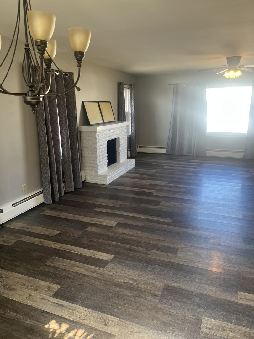 125 West Exchange Street Danvers, IL 61732 - Photo 8 of 66 a view of a livingroom with wooden floor and window