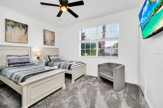 a bedroom with a bed couch and a window