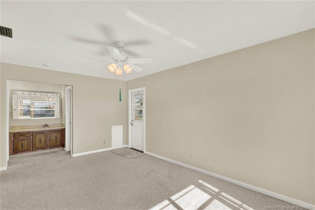 902 Savannas Point Drive, Unit D Fort Pierce, FL 34982 - Photo 16 of 44 wooden floor in an empty room with a window