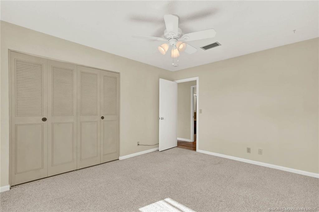 902 Savannas Point Drive, Unit D Fort Pierce, FL 34982 - Photo 22 of 44 a view of an empty room and chandelier fan