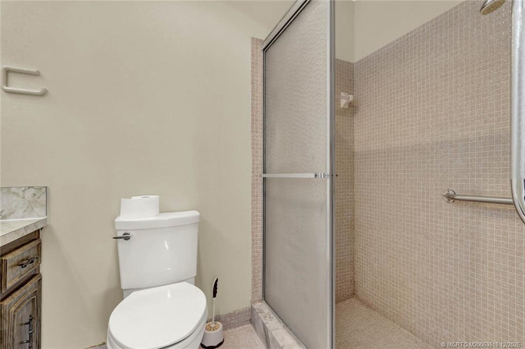 902 Savannas Point Drive, Unit D Fort Pierce, FL 34982 - Photo 25 of 44 a white toilet sitting next to a bathroom sink