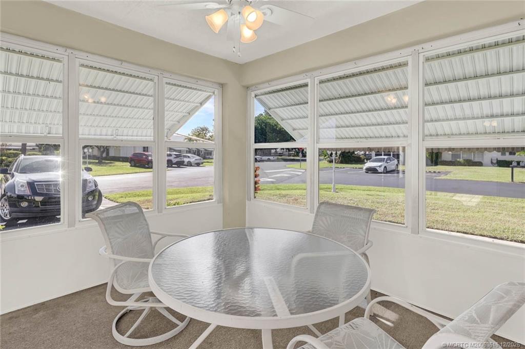 902 Savannas Point Drive, Unit D Fort Pierce, FL 34982 - Photo 26 of 44 a dining room with furniture and a floor to ceiling window