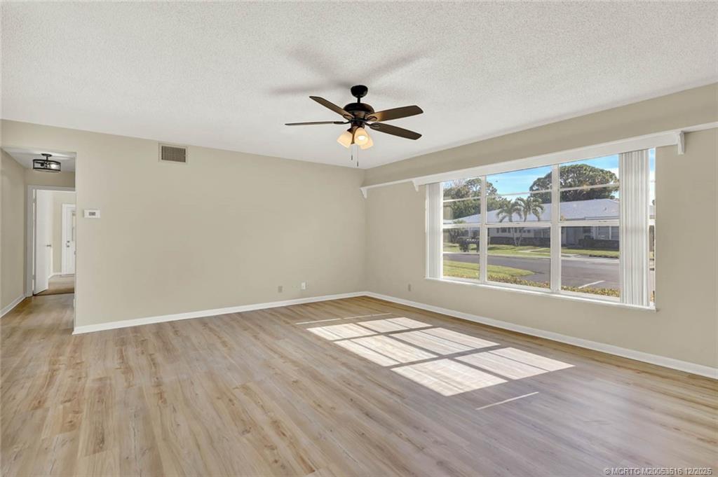 902 Savannas Point Drive, Unit D Fort Pierce, FL 34982 - Photo 4 of 44 an empty room with wooden floor and windows