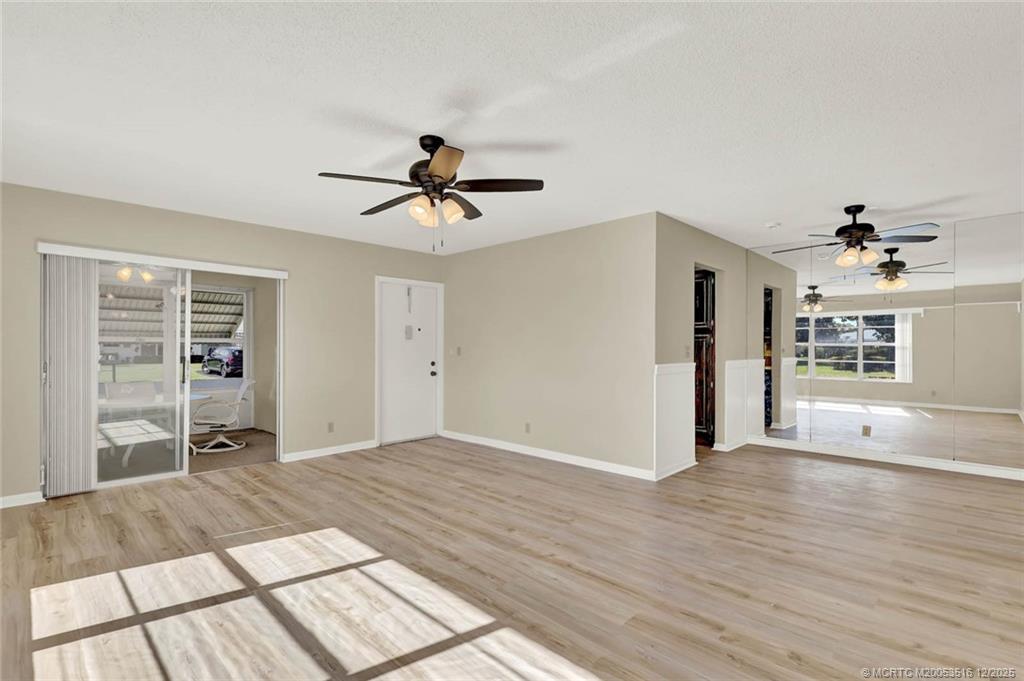 902 Savannas Point Drive, Unit D Fort Pierce, FL 34982 - Photo 6 of 44 a view of a livingroom with wooden floor and a ceiling fan