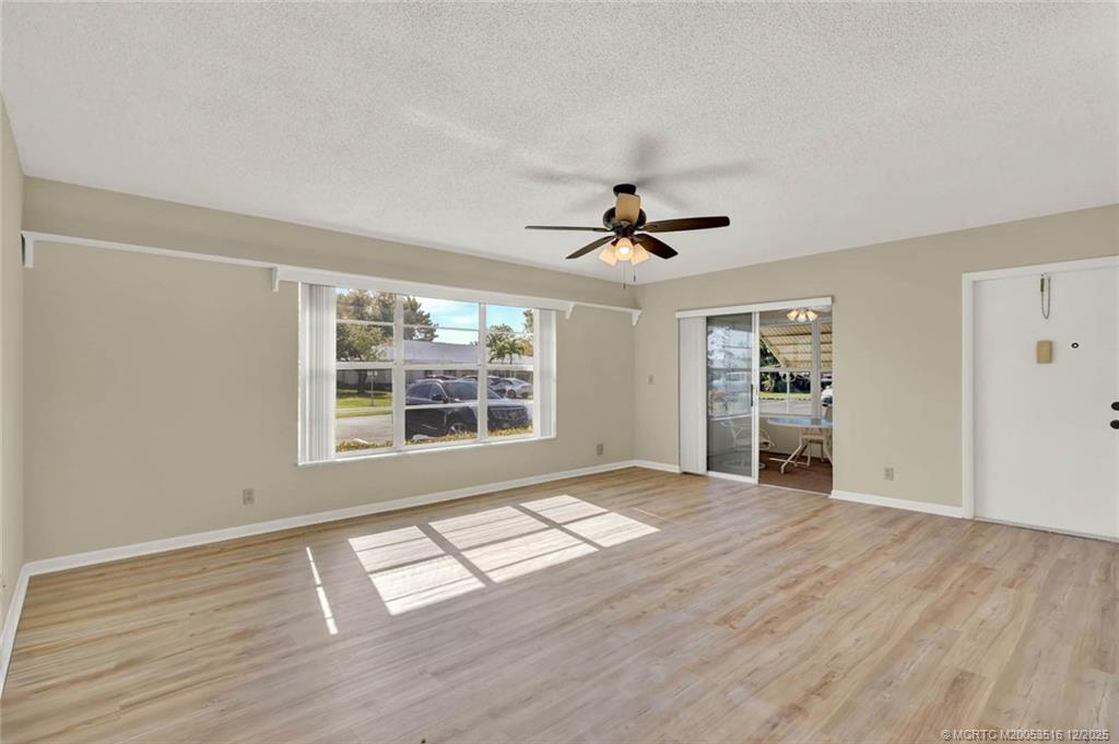 902 Savannas Point Drive, Unit D Fort Pierce, FL 34982 - Photo 7 of 44 a view of an empty room with a window and wooden floor