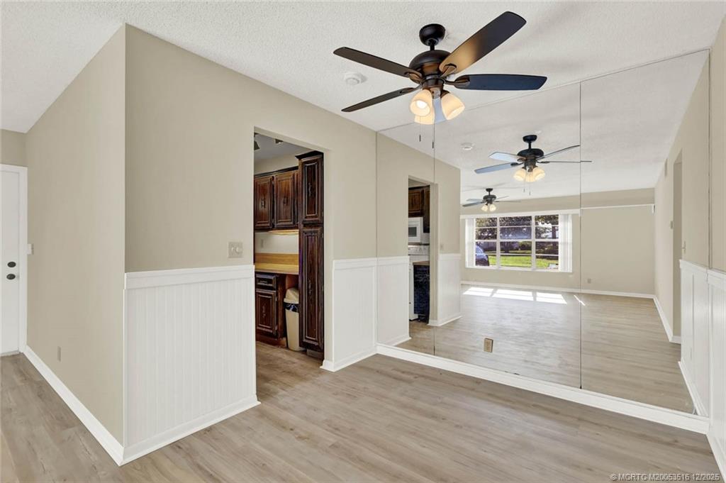 902 Savannas Point Drive, Unit D Fort Pierce, FL 34982 - Photo 8 of 44 a view of empty room with wooden floor and ceiling fan