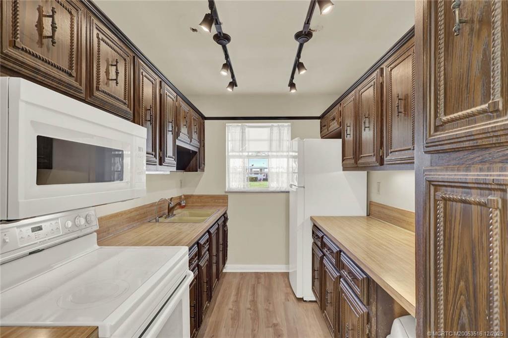 902 Savannas Point Drive, Unit D Fort Pierce, FL 34982 - Photo 9 of 44 a kitchen with a sink stove and refrigerator