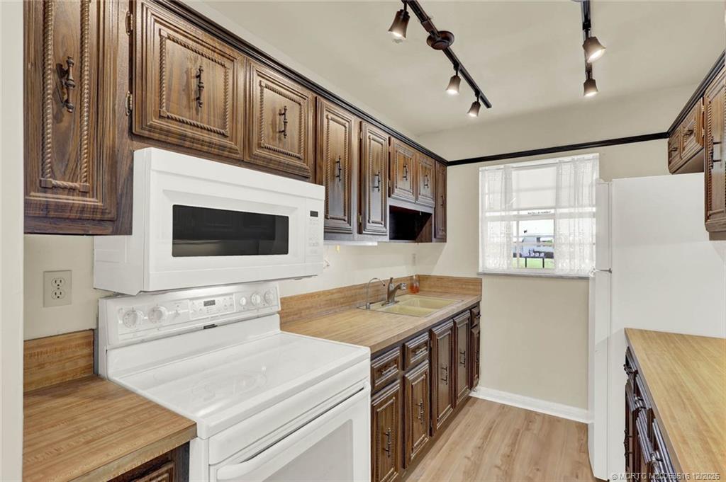 902 Savannas Point Drive, Unit D Fort Pierce, FL 34982 - Photo 10 of 44 a kitchen with stainless steel appliances granite countertop a stove and a microwave