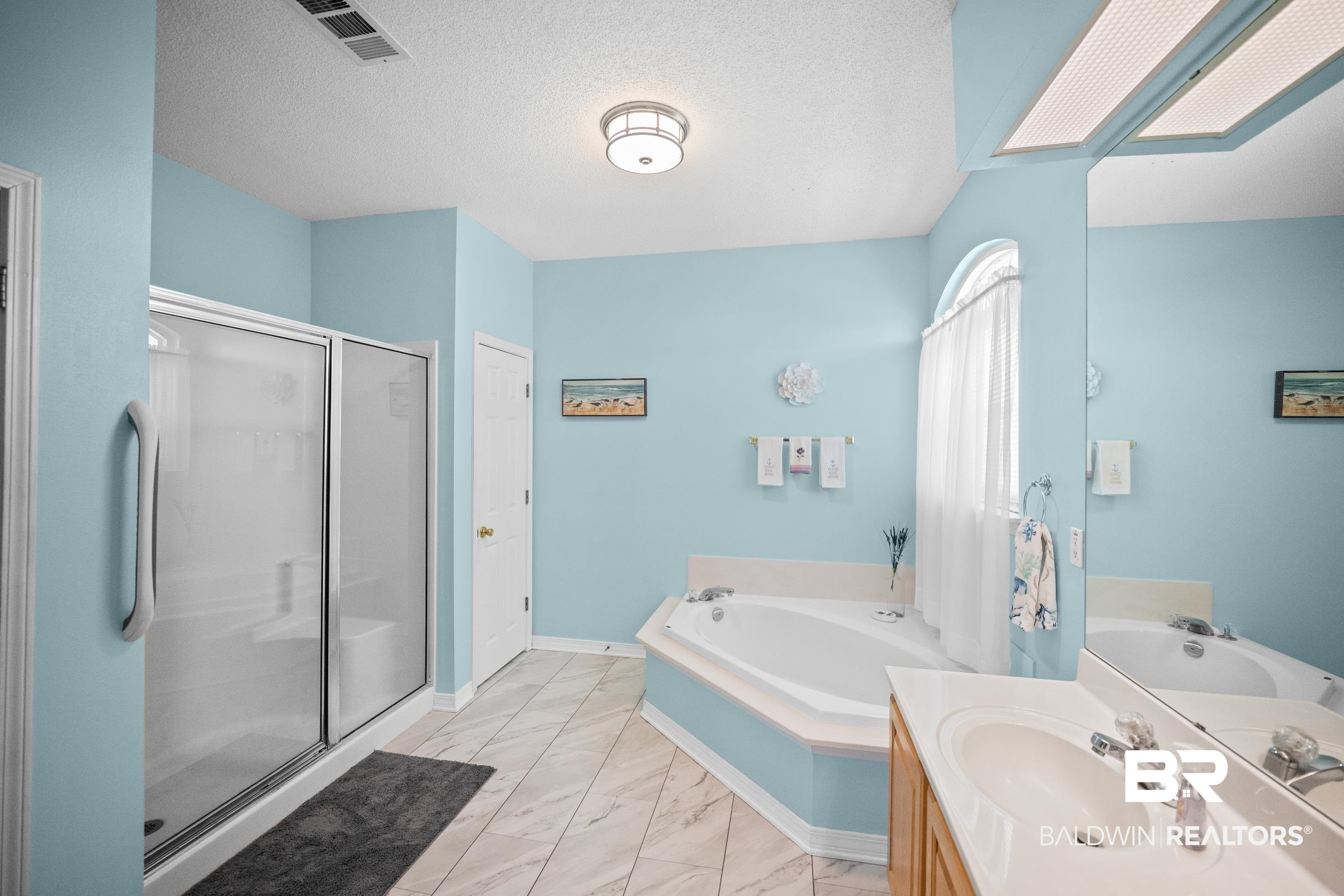 22355 East County Road 12 Foley, AL 36535 - Photo 31 of 54 Bathroom with a textured ceiling, vanity, a bath, a stall shower, and light marble finish flooring
