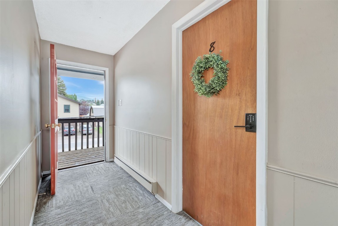 259 6th Street, Unit 8 Steamboat Springs, CO 80487 - Photo 22 of 33 hallway with wooden floor and table