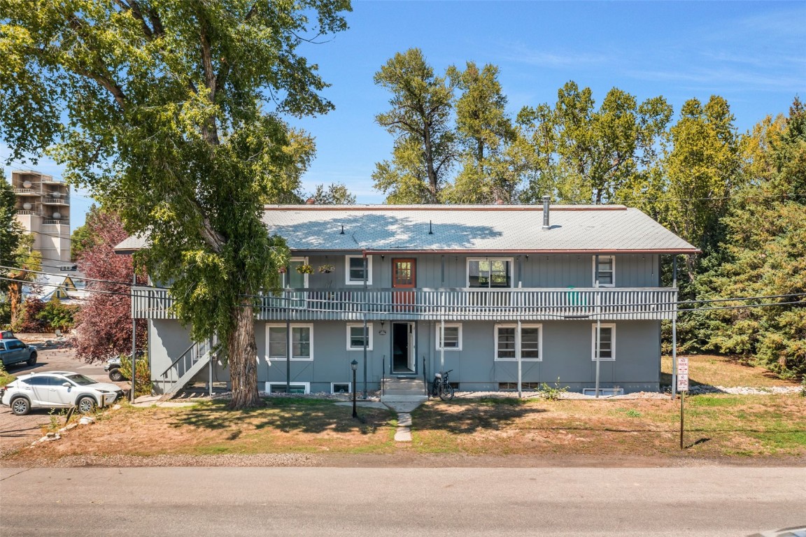 259 6th Street, Unit 8 Steamboat Springs, CO 80487 - Photo 29 of 33 a view of a big house with large trees and plants