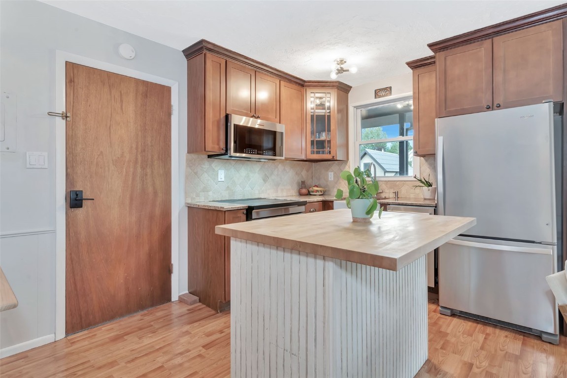 259 6th Street, Unit 8 Steamboat Springs, CO 80487 - Photo 3 of 33 a kitchen with stainless steel appliances granite countertop a refrigerator a sink and a stove