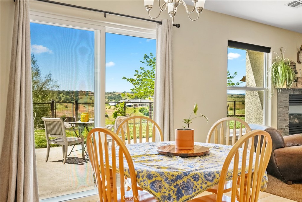 5950 Forked Horn Place Paso Robles, CA 93446 - Photo 14 of 31 a view of a dining room with furniture a chandelier and wooden floor