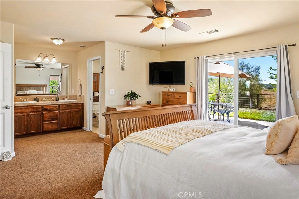 5950 Forked Horn Place Paso Robles, CA 93446 - Photo 17 of 31 a bedroom with a bed and a flat screen tv