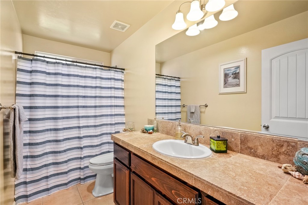 5950 Forked Horn Place Paso Robles, CA 93446 - Photo 22 of 31 a bathroom with a granite countertop sink and a mirror