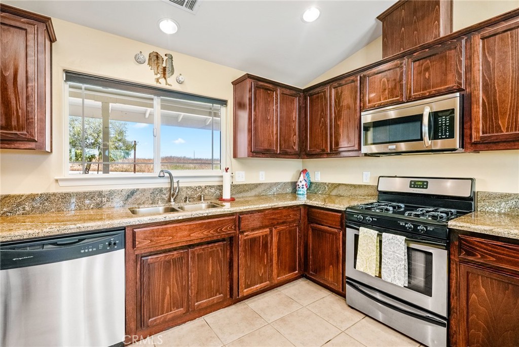 5950 Forked Horn Place Paso Robles, CA 93446 - Photo 6 of 31 a kitchen with stainless steel appliances granite countertop a stove sink microwave and cabinets
